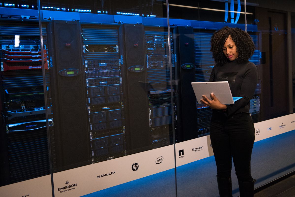 An engineer monitoring server racks in a data center.